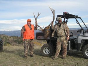 Hunter with Elk in back of Polaris