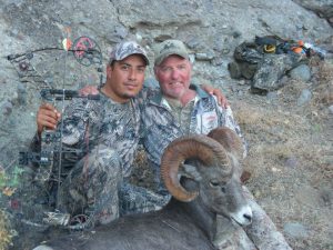 Hunter and guide with their ram