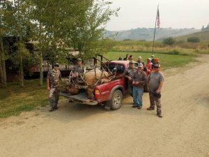 Hunters and guides gather around truck with all of their Elks