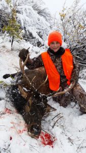 Small hunter in the snow with his Elk