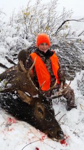 Kid hunter with his deer