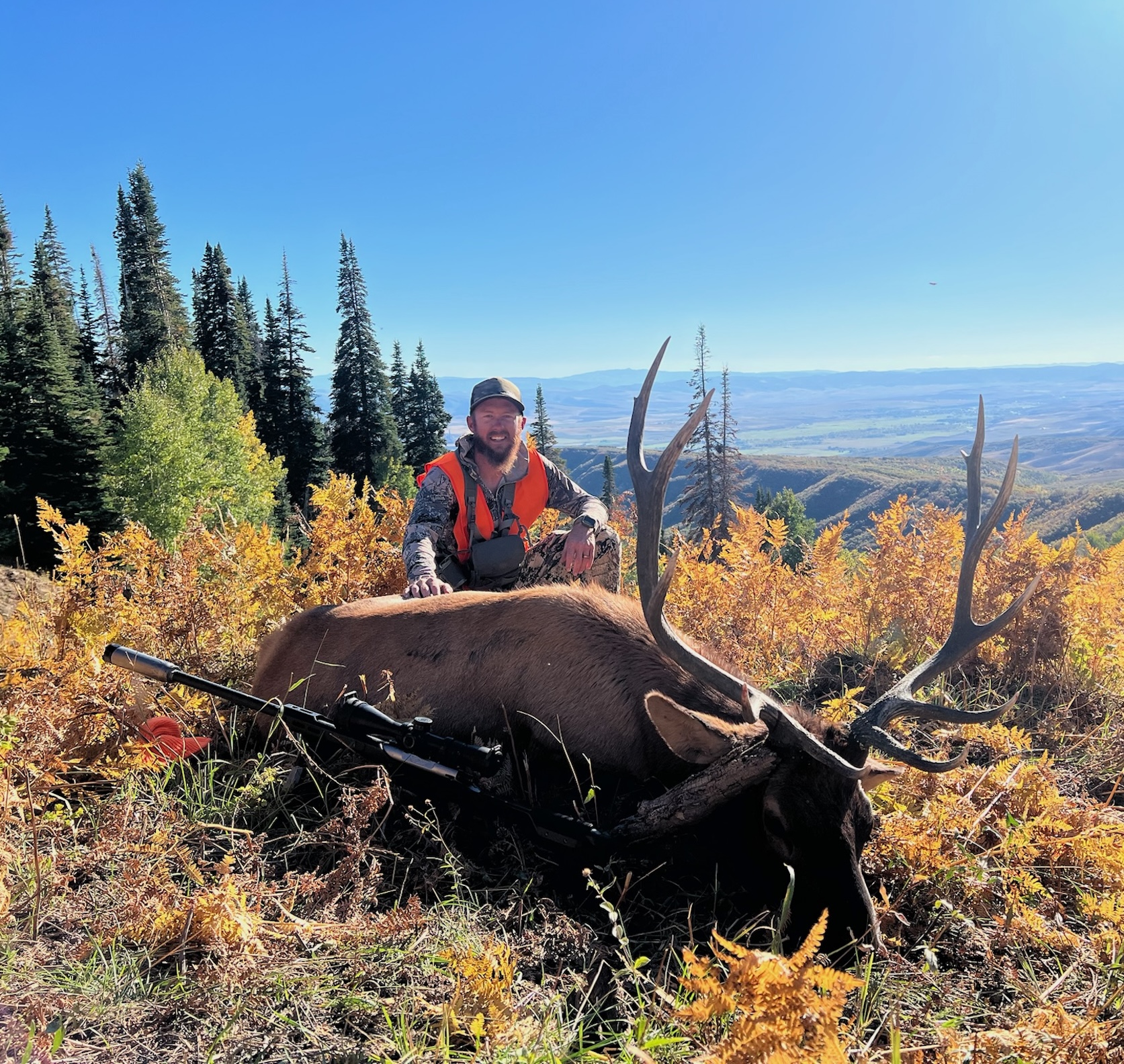 Hunter with Elk in woods during the fall